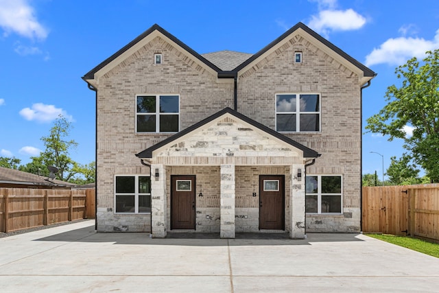 102 Schade Ln, Houston, TX 77037 - view of front of home with brick siding, covered porch, and stone siding