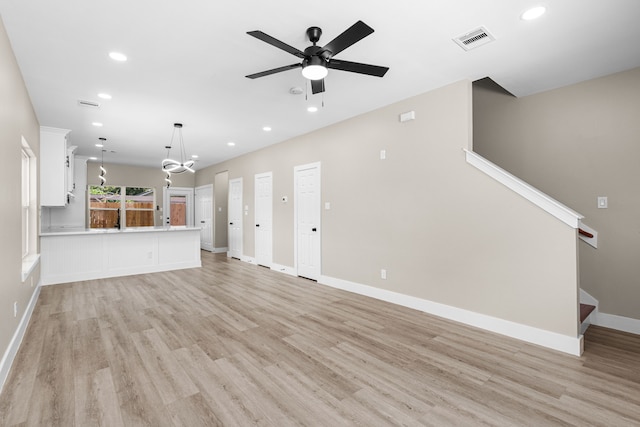 102 Schade Ln, Houston, TX 77037 - unfurnished living room featuring light wood finished floors, ceiling fan, recessed lighting, stairs, and baseboards
