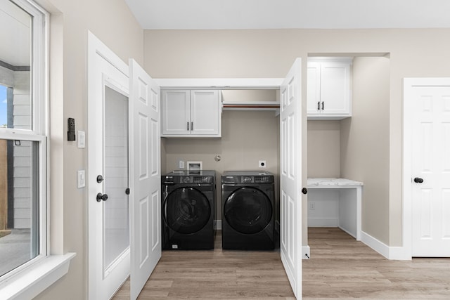 102 Schade Ln, Houston, TX 77037 - clothes washing area with cabinet space, independent washer and dryer, light wood finished floors, and baseboards