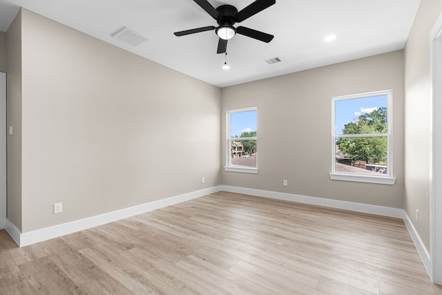 102 Schade Ln, Houston, TX 77037 - spare room with healthy amount of natural light, light wood-style flooring, a ceiling fan, baseboards, and recessed lighting