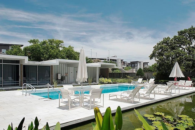 5050 Woodway Dr Unit 2A, Houston, TX 77056 - community pool featuring a patio and fence