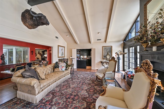 435 Flint Point Dr, Houston, TX 77024 - living room with healthy amount of natural light, wood finished floors, a high end fireplace, beam ceiling, and high vaulted ceiling