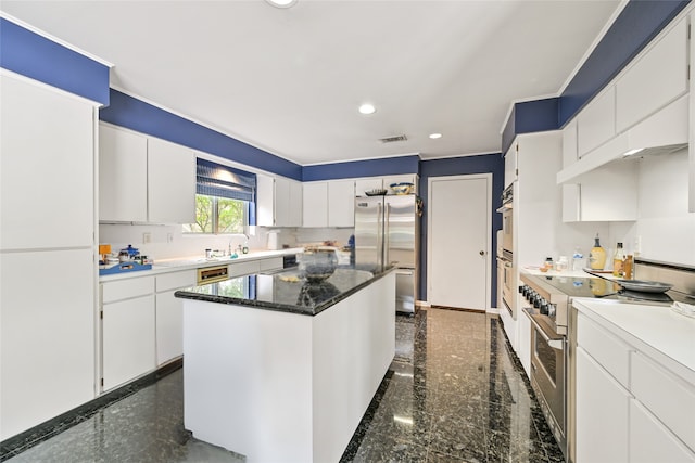 435 Flint Point Dr, Houston, TX 77024 - kitchen with high quality appliances, granite tiled floors, recessed lighting, a kitchen island, and white cabinetry