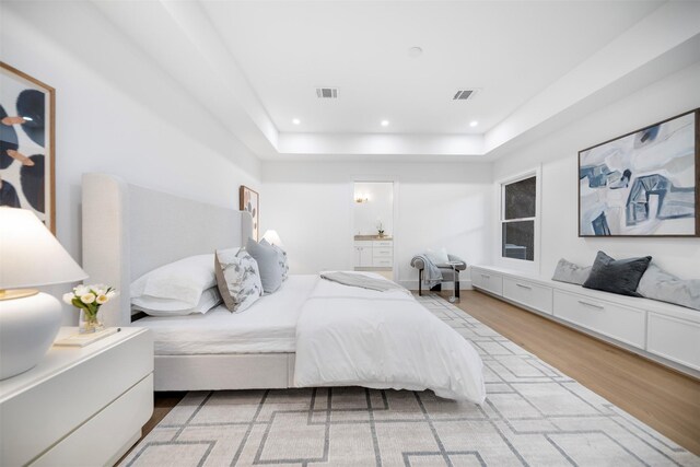608 W Main St, Houston, TX 77006 - bedroom with wood finished floors, recessed lighting, ensuite bathroom, and a raised ceiling