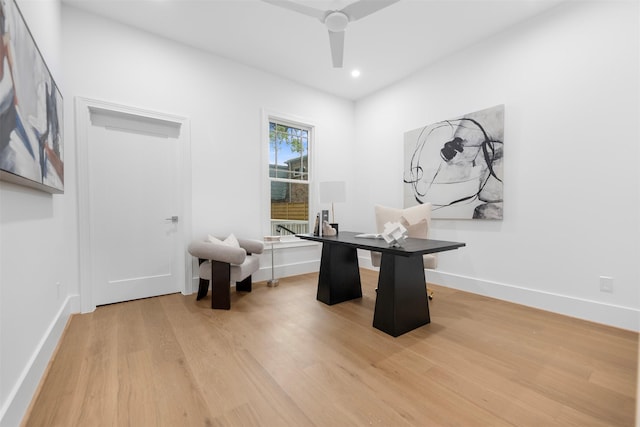 unfurnished office with light wood finished floors, a ceiling fan, recessed lighting, and baseboards