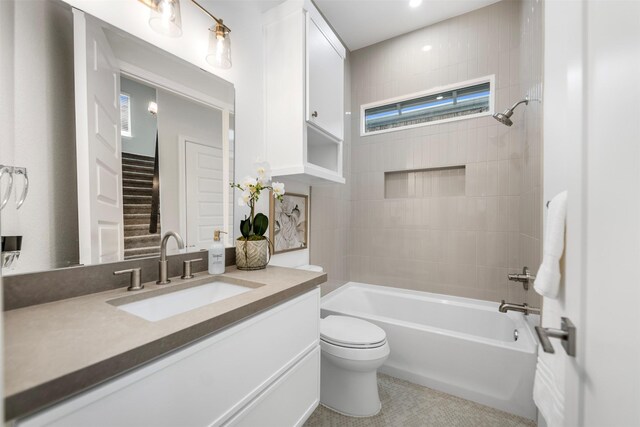 608 W Main St, Houston, TX 77006 - bathroom featuring toilet, vanity, washtub / shower combination, and tile patterned flooring