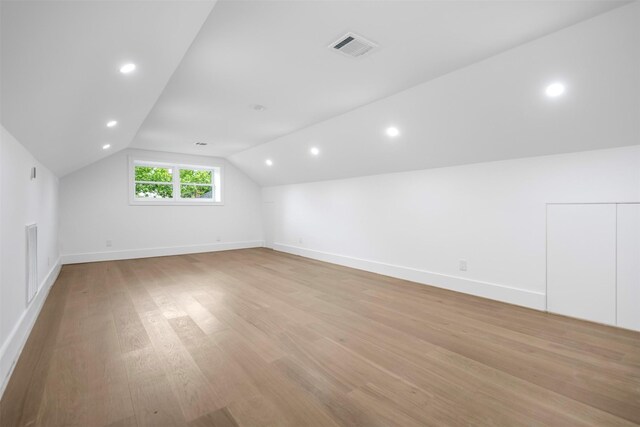 608 W Main St, Houston, TX 77006 - additional living space with light wood-style flooring, lofted ceiling, baseboards, and recessed lighting