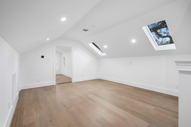 608 W Main St, Houston, TX 77006 - bonus room with a skylight, lofted ceiling, light wood-type flooring, recessed lighting, and baseboards