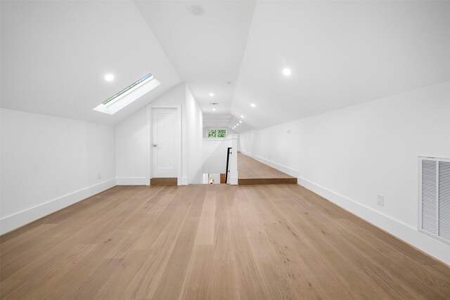 608 W Main St, Houston, TX 77006 - additional living space with a skylight, vaulted ceiling, light wood-style flooring, baseboards, and recessed lighting