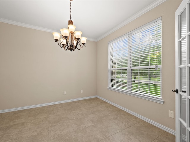 spare room with a chandelier, crown molding, and baseboards