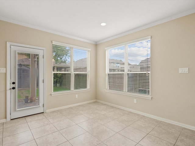 unfurnished room with ornamental molding, baseboards, and light tile patterned flooring