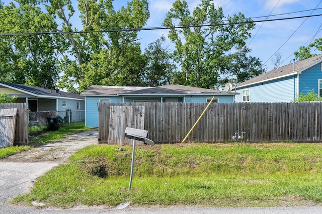 view of yard featuring fence and driveway