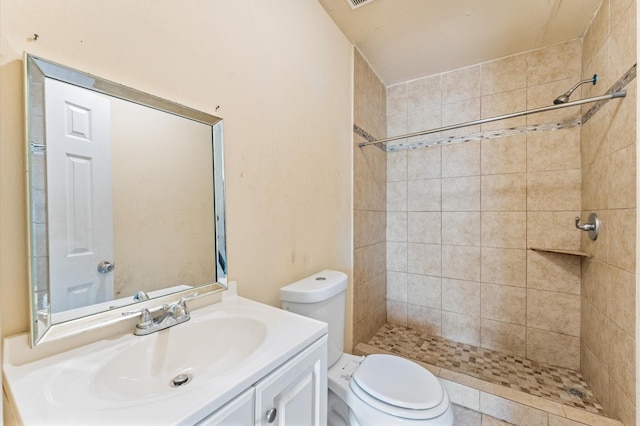 full bathroom featuring toilet, a stall shower, and vanity