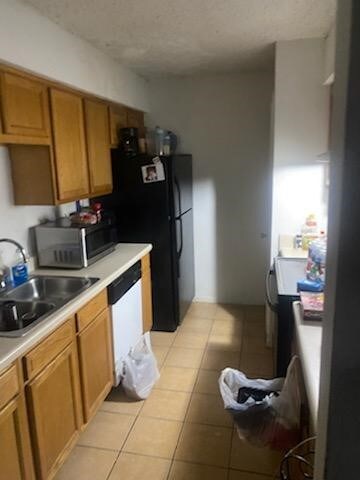 10555 Turtlewood Ct Unit 1601, Houston, TX 77072 - kitchen with a sink, stainless steel microwave, dishwasher, and light countertops