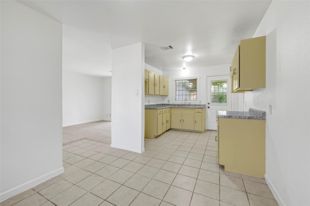 9310 Woodlyn Rd, Houston, TX 77078 - kitchen with light tile patterned flooring, a sink, and baseboards