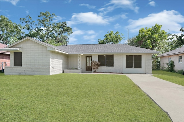 9310 Woodlyn Rd, Houston, TX 77078 - view of front of house featuring brick siding, a front lawn, and a shingled roof