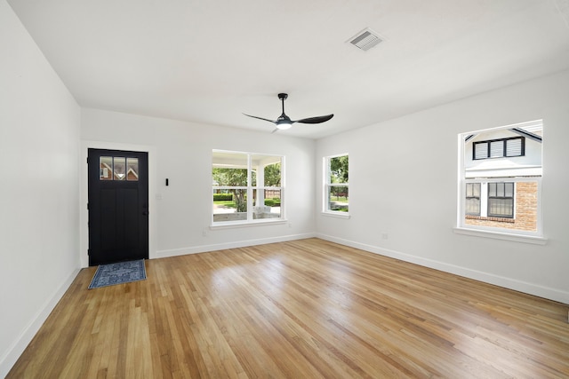 foyer with baseboards, light wood-type flooring, and a ceiling fan