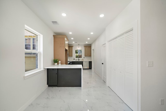 kitchen featuring a peninsula, recessed lighting, decorative backsplash, light countertops, and baseboards