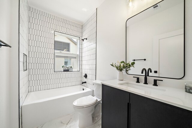 full bathroom featuring toilet, marble finish flooring, vanity, and shower / tub combination