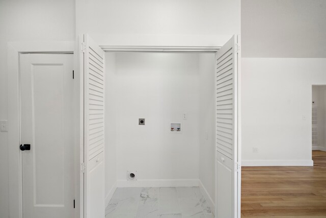 laundry room featuring electric dryer hookup, hookup for a washing machine, baseboards, and light marble finish floors