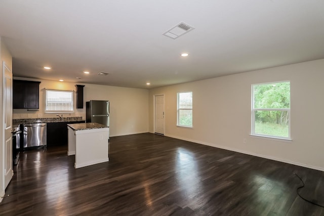 862 Rachel St, Houston, TX 77091 - kitchen featuring freestanding refrigerator, stainless steel dishwasher, a center island, open floor plan, and dark wood finished floors