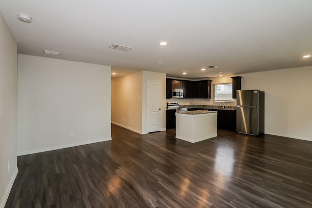 862 Rachel St, Houston, TX 77091 - kitchen featuring appliances with stainless steel finishes, a center island, dark wood finished floors, open floor plan, and baseboards