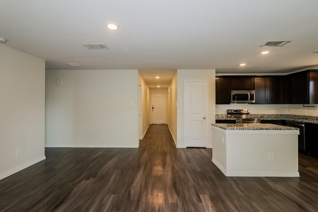 862 Rachel St, Houston, TX 77091 - kitchen with appliances with stainless steel finishes, dark wood finished floors, a kitchen island, stone counters, and recessed lighting