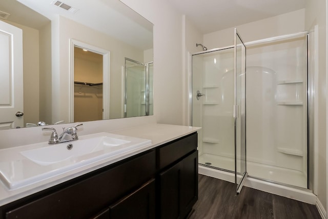 862 Rachel St, Houston, TX 77091 - bathroom featuring a shower stall, wood finished floors, vanity, and a spacious closet