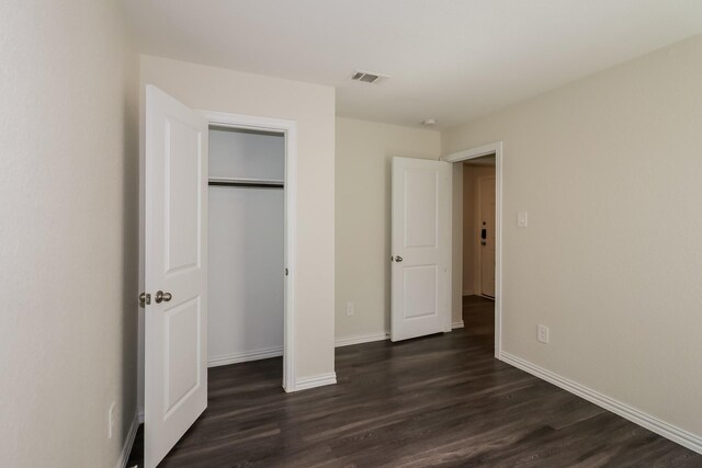 862 Rachel St, Houston, TX 77091 - unfurnished bedroom with dark wood finished floors, baseboards, and a closet