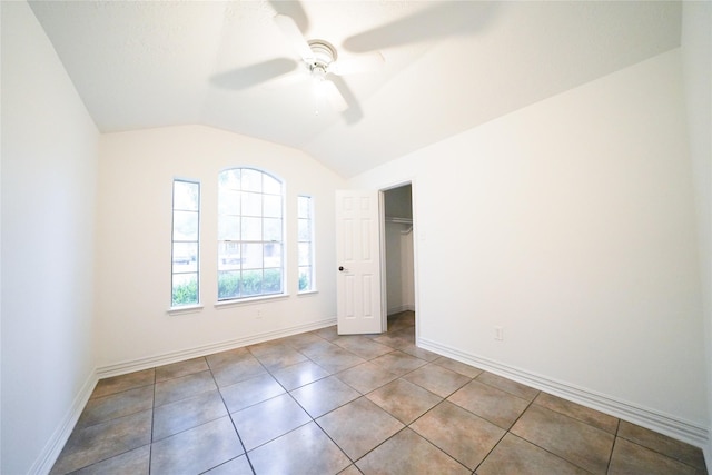 5006 Dawngate Dr, Spring, TX 77373 - unfurnished bedroom with vaulted ceiling, baseboards, tile patterned floors, a ceiling fan, and a closet