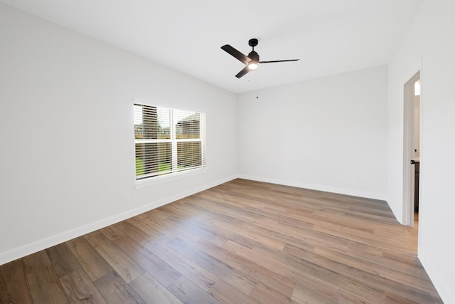6171 White Spruce Dr, Conroe, TX 77304 - empty room featuring light wood-type flooring, a ceiling fan, and baseboards