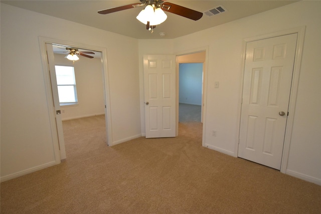 empty room featuring light carpet, ceiling fan, and baseboards