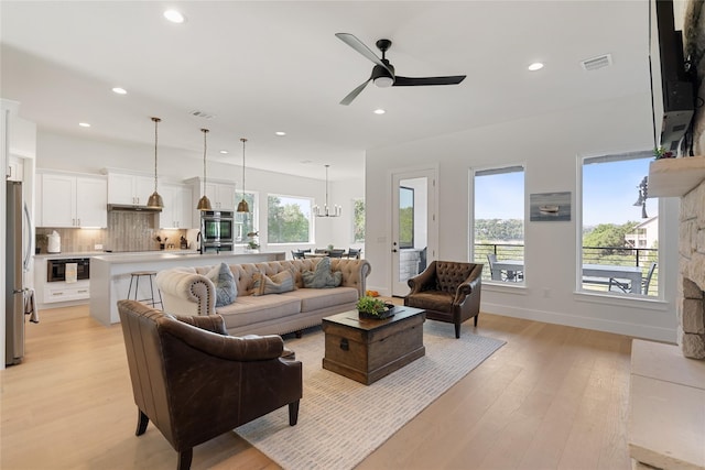 18605 Lakeland Dr, Point Venture, TX 78645 - living area featuring light wood finished floors, recessed lighting, ceiling fan, a chandelier, and baseboards