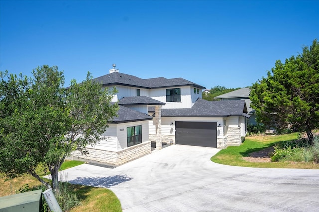 18605 Lakeland Dr, Point Venture, TX 78645 - view of front facade with concrete driveway, stone siding, and roof with shingles