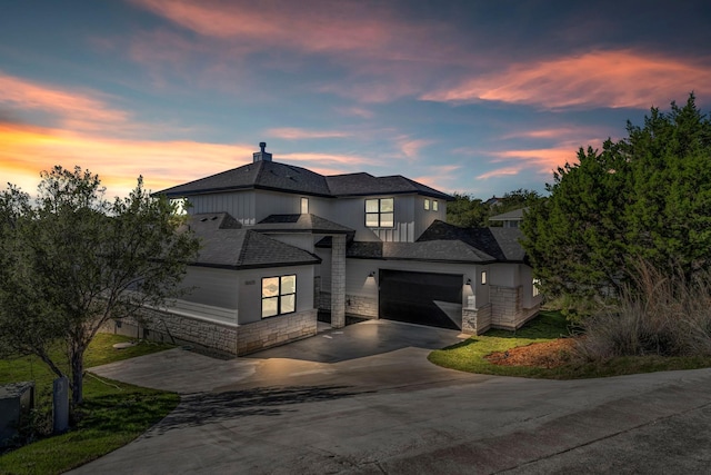 18605 Lakeland Dr, Point Venture, TX 78645 - view of front facade featuring driveway, stone siding, stucco siding, an attached garage, and roof with shingles