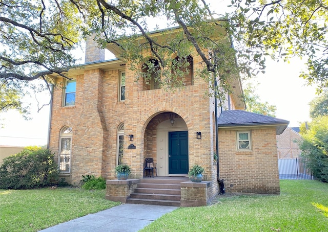 view of front of home with a chimney and brick siding