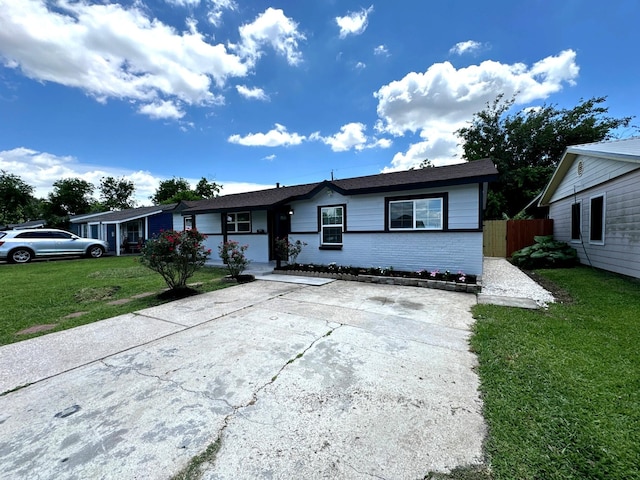 single story home with brick siding and concrete driveway