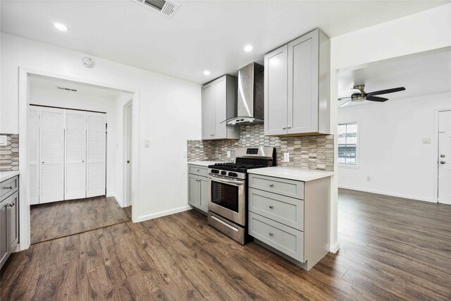 508 Kalmer St, Pasadena, TX 77502 - kitchen featuring stainless steel gas range, wall chimney range hood, gray cabinets, ceiling fan, and tasteful backsplash