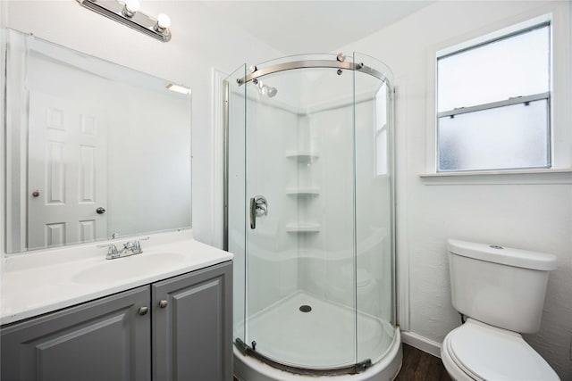 508 Kalmer St, Pasadena, TX 77502 - full bath with wood finished floors, a shower stall, toilet, vanity, and baseboards