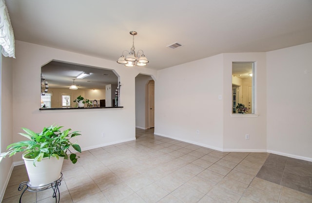 10406 Tenleyton Ln, Houston, TX 77075 - tiled empty room featuring arched walkways, a chandelier, baseboards, and a sink