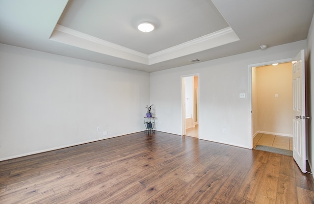 10406 Tenleyton Ln, Houston, TX 77075 - empty room featuring a tray ceiling, crown molding, wood finished floors, and baseboards