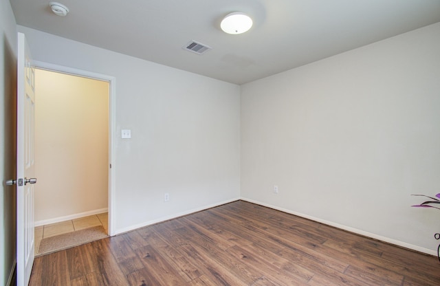 10406 Tenleyton Ln, Houston, TX 77075 - empty room featuring wood finished floors, a smoke detector, and baseboards