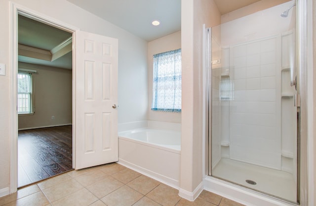 10406 Tenleyton Ln, Houston, TX 77075 - full bathroom with a stall shower, a garden tub, tile patterned flooring, and ornamental molding