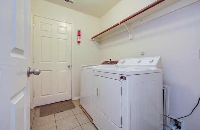 10406 Tenleyton Ln, Houston, TX 77075 - washroom featuring separate washer and dryer and light tile patterned flooring