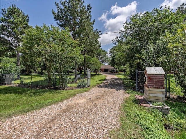 21007 Cook Rd, Tomball, TX 77377 - view of dirt / gravel road featuring a gated entry and a gate