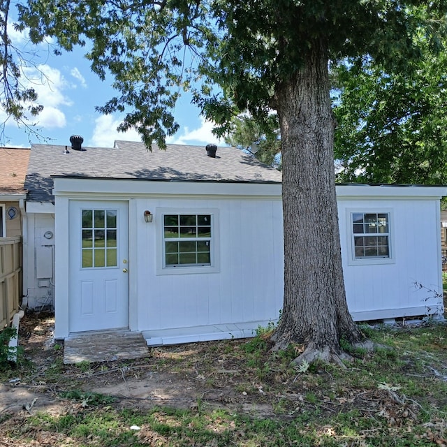 18 Townhouse Ln Unit 18, Trinity, TX 75862 - back of house featuring roof with shingles