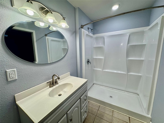 18 Townhouse Ln Unit 18, Trinity, TX 75862 - bathroom featuring a shower stall, tile patterned flooring, vanity, and a textured wall