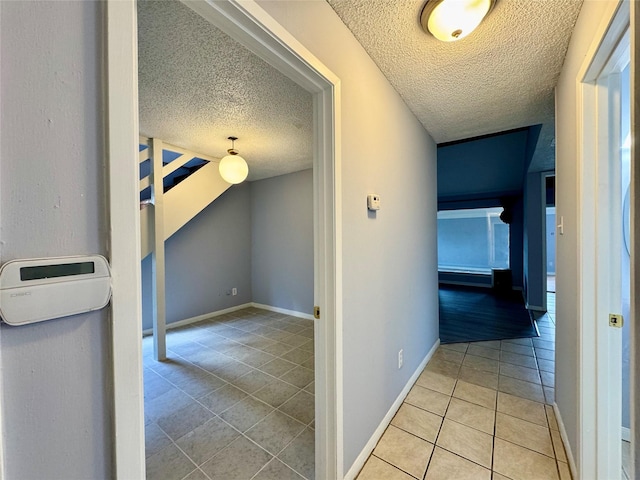 18 Townhouse Ln Unit 18, Trinity, TX 75862 - hall featuring a textured ceiling, tile patterned flooring, and baseboards