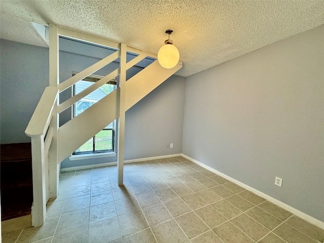 18 Townhouse Ln Unit 18, Trinity, TX 75862 - unfurnished bedroom featuring a textured ceiling, tile patterned flooring, and baseboards