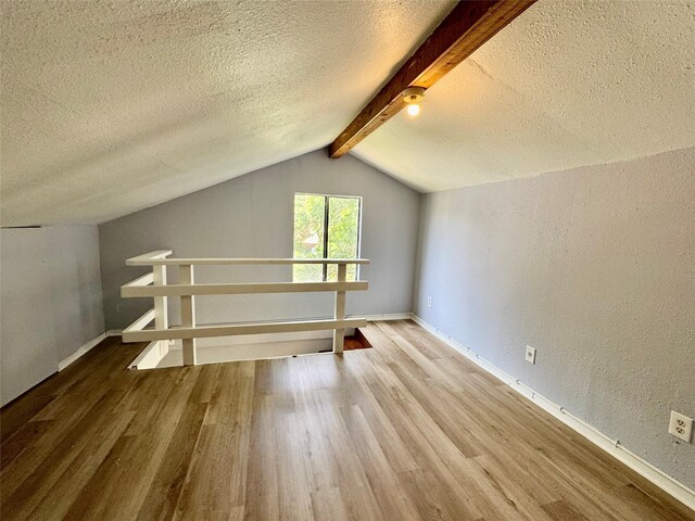 18 Townhouse Ln Unit 18, Trinity, TX 75862 - additional living space with wood finished floors, a textured ceiling, baseboards, and a textured wall